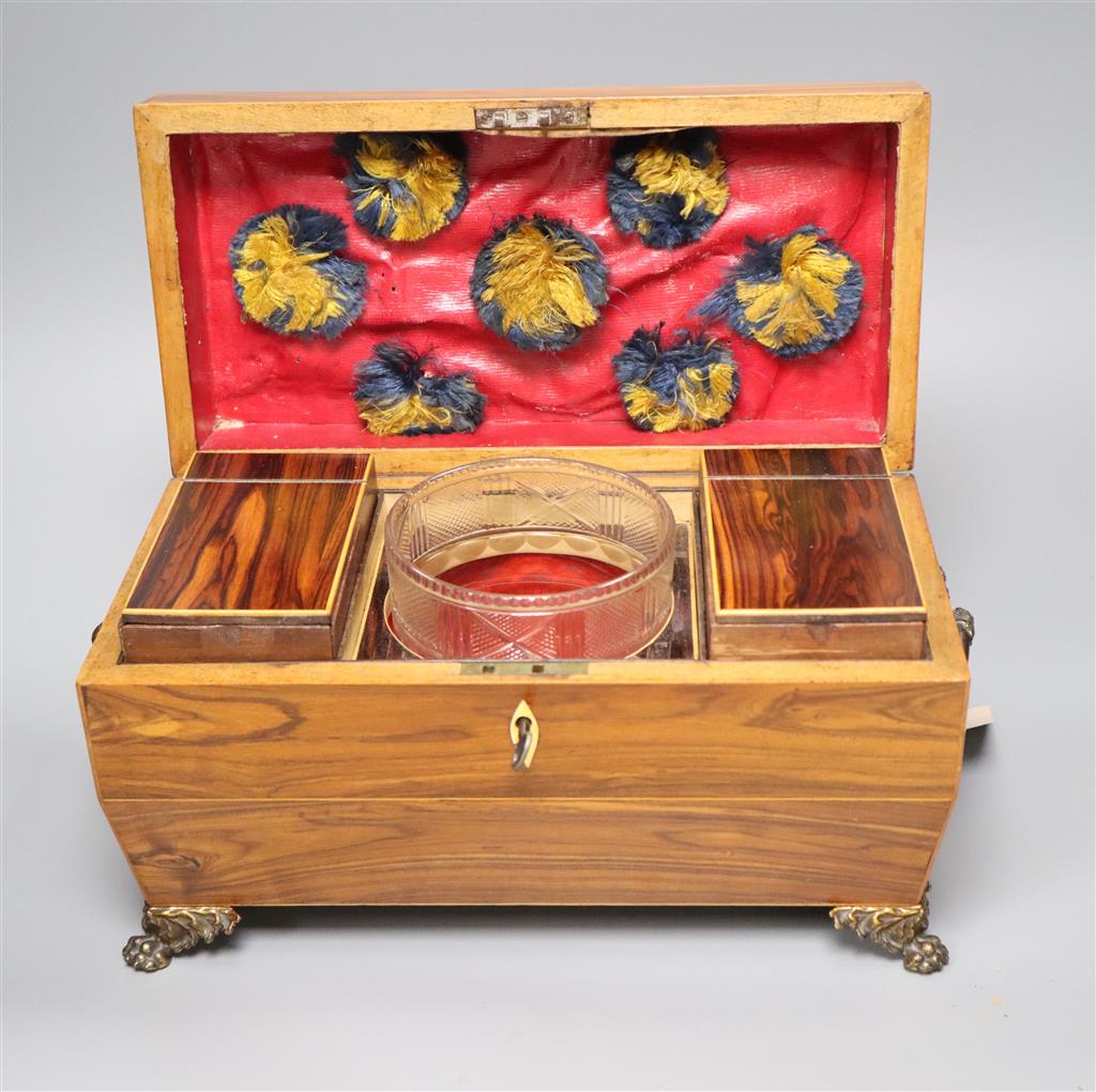 A Regency kingwood sarcophagus tea caddy fitted two containers and a cut glass bowl